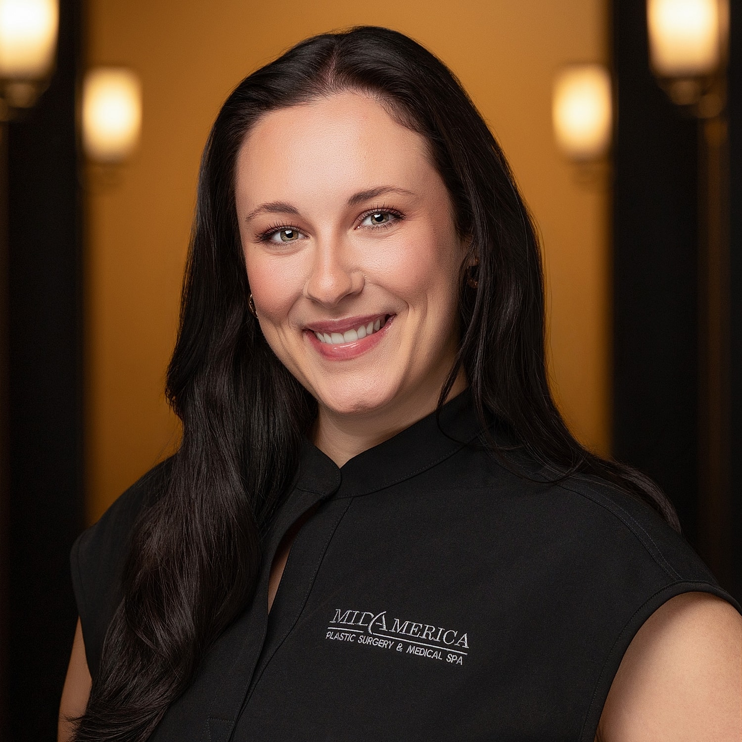 Smiling woman in professional attire at spa.