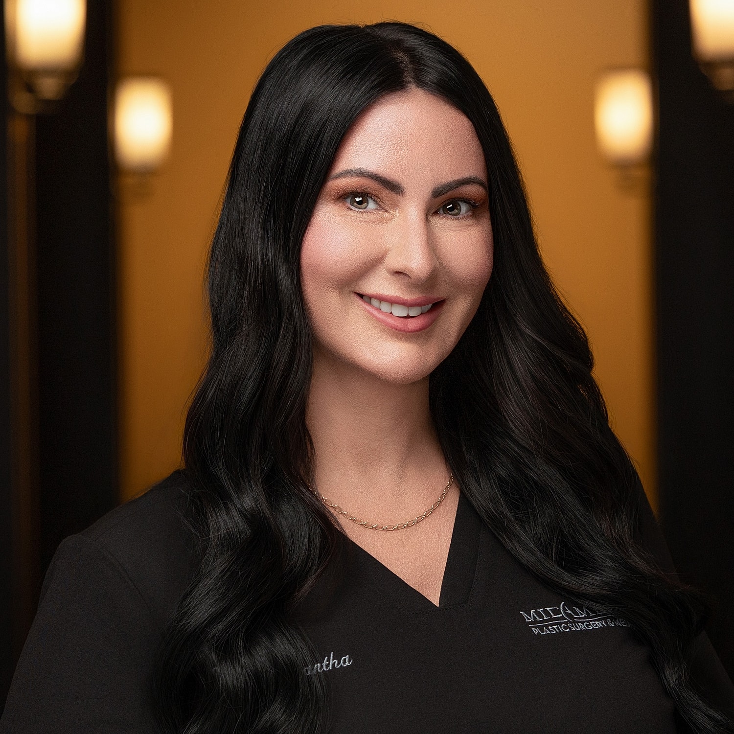 Professional woman smiling in medical attire.