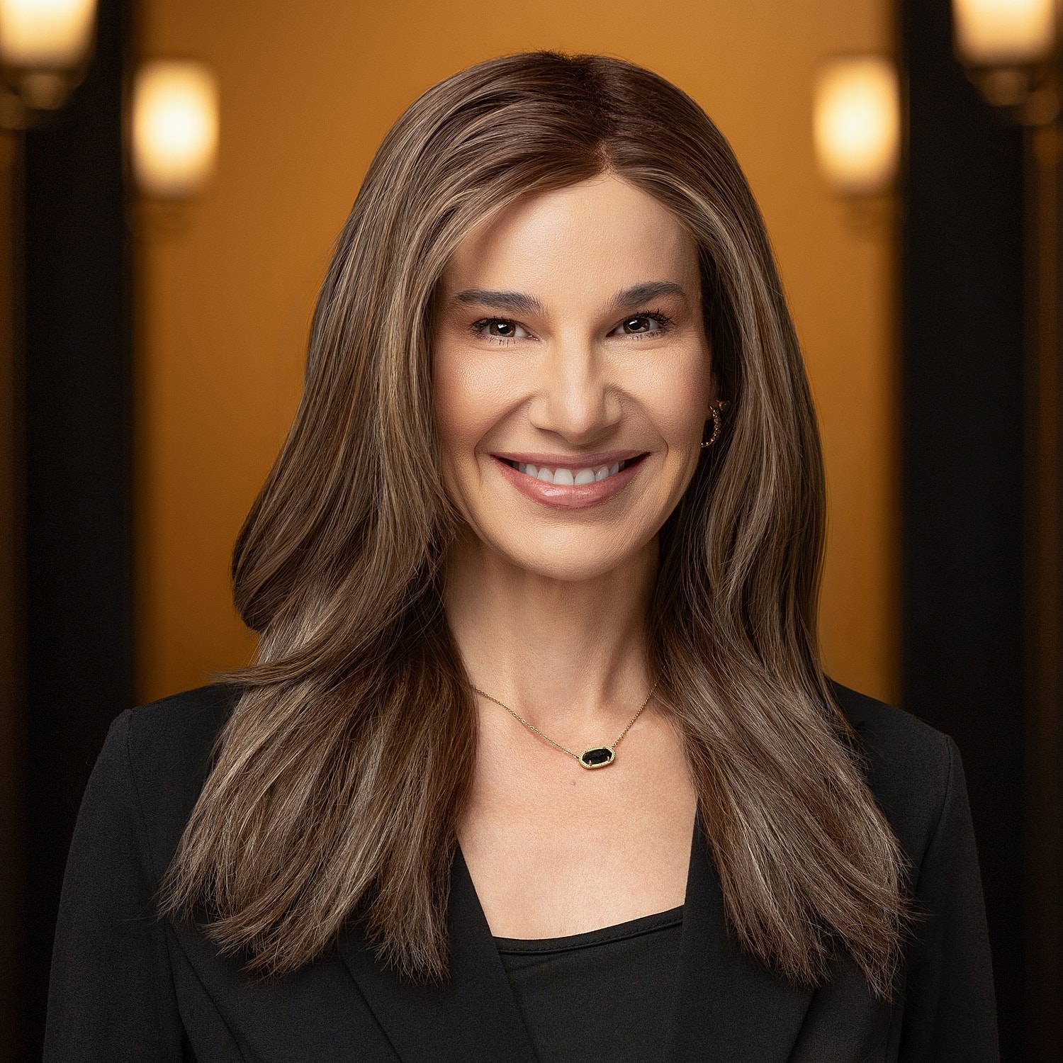 Smiling woman with long brown hair.