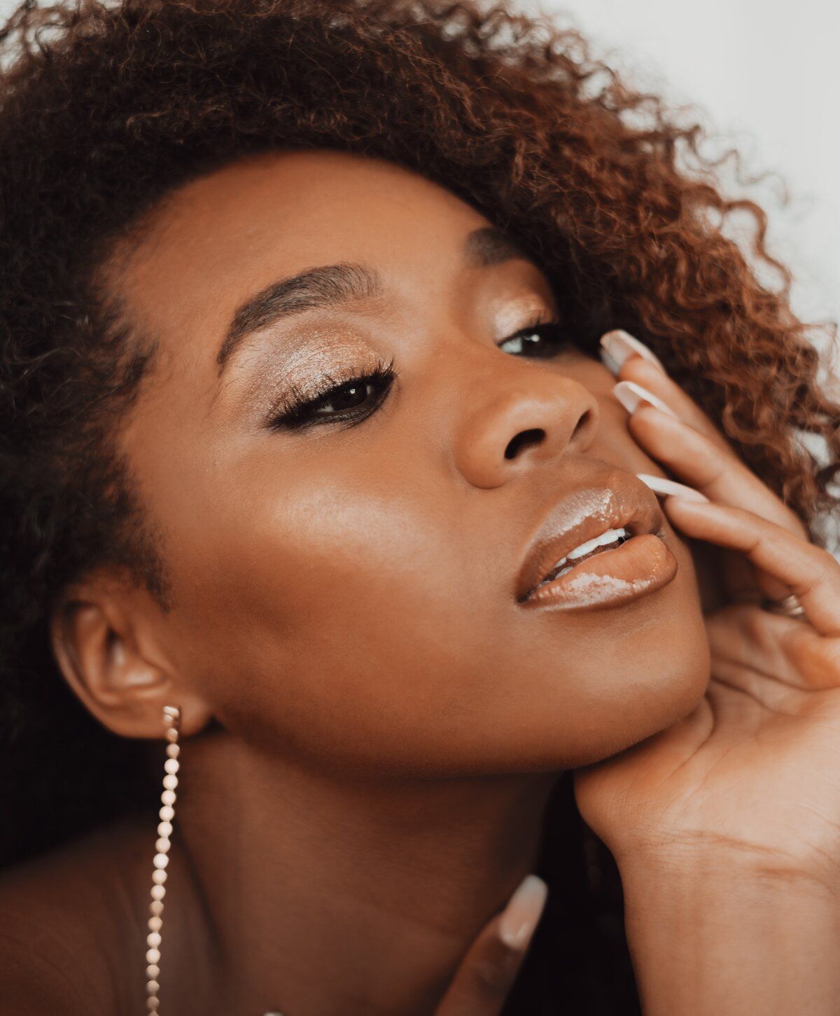 Close-up of a woman with curly hair.