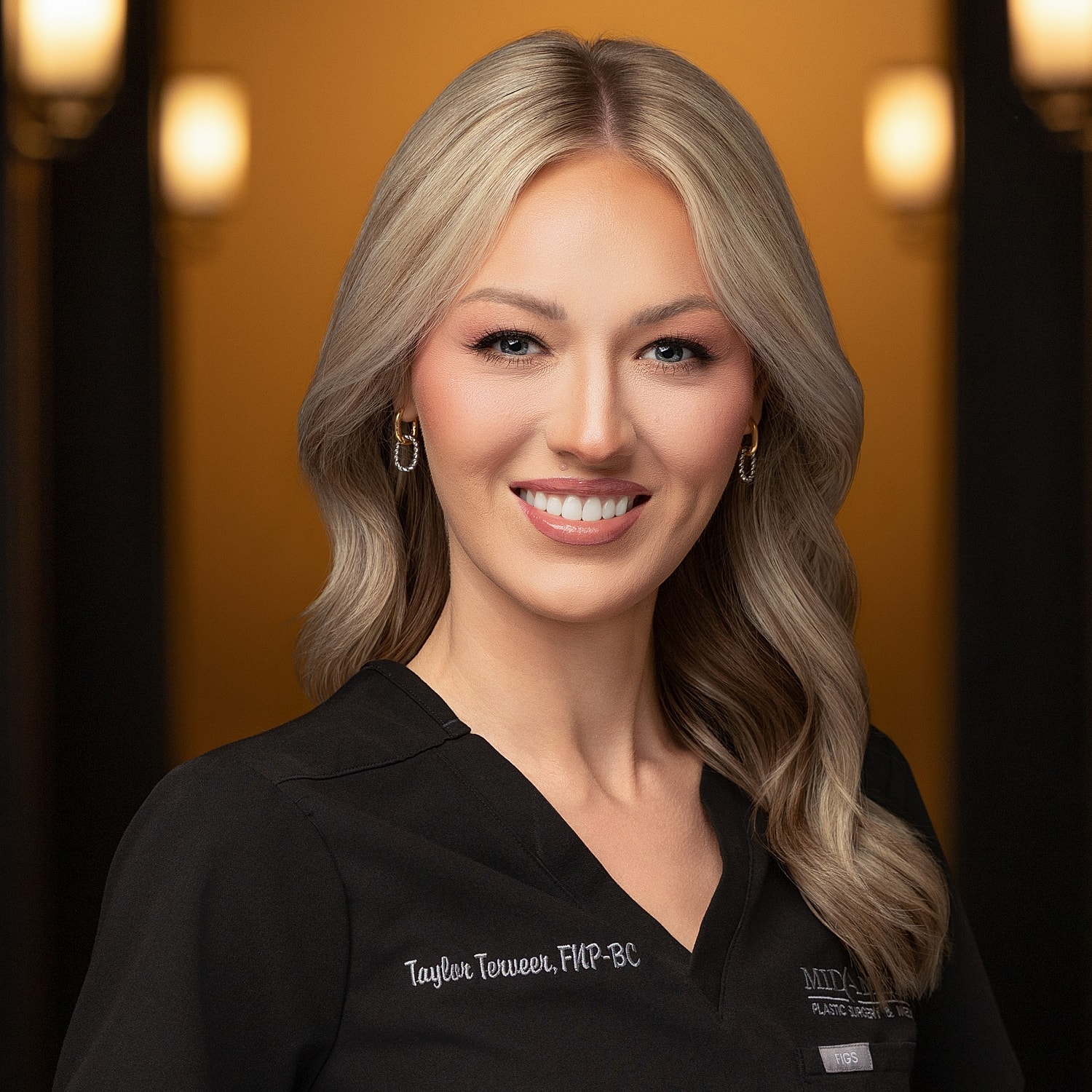 Smiling healthcare professional in black attire.