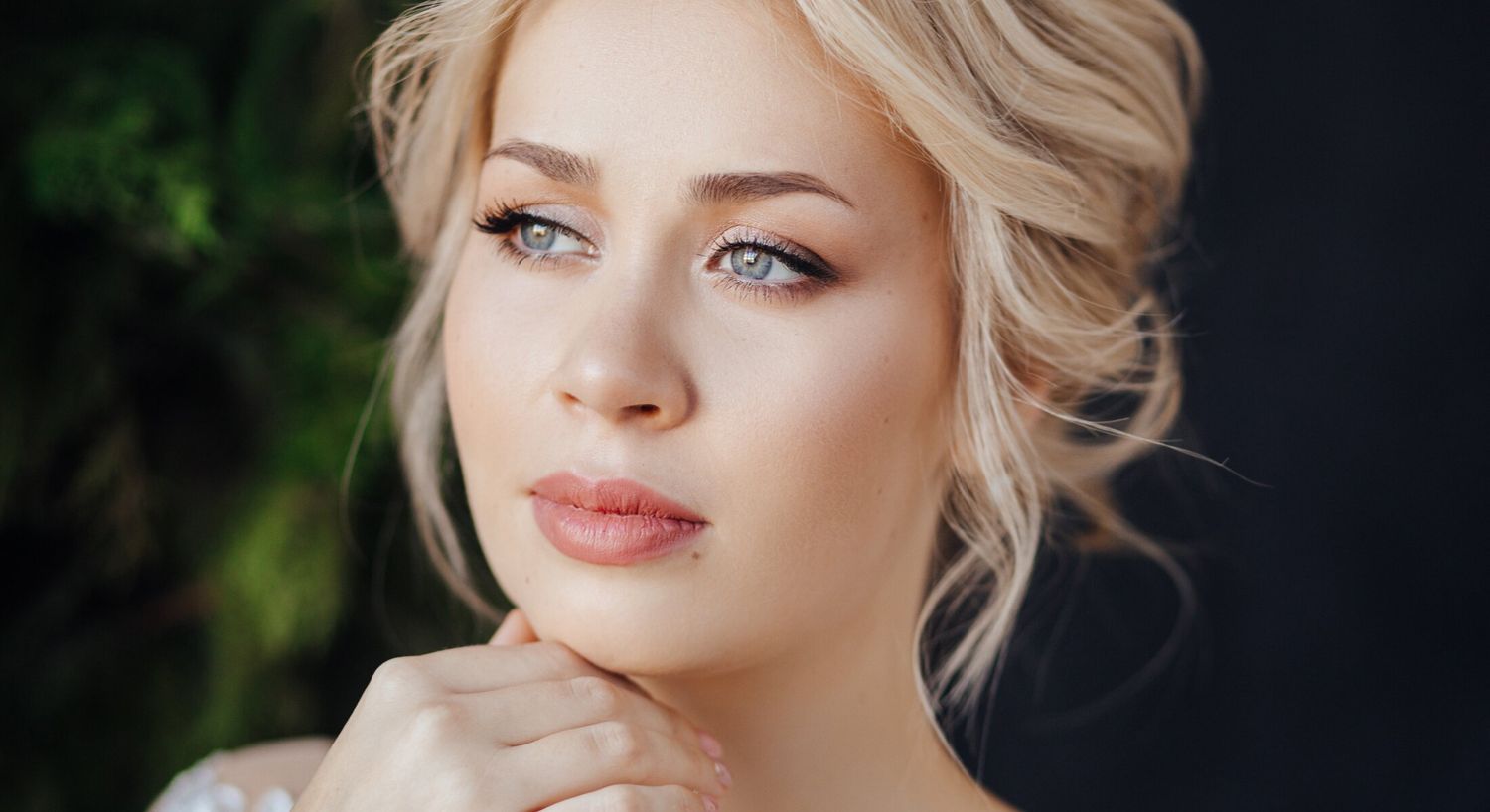 Portrait of a thoughtful woman with blonde hair.