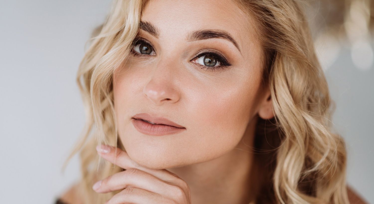 Close-up portrait of a woman with thoughtful expression.